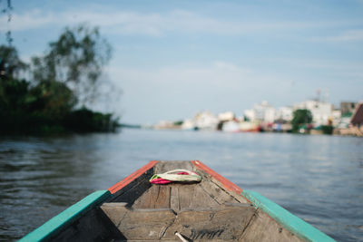 Boat moored on river against sky