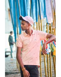 Young man looking away while standing outdoors