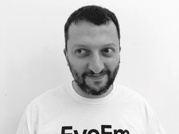 Portrait of mid adult man against white background