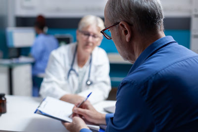 Doctor examining patient in office