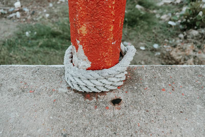 High angle view of rope tied up on footpath