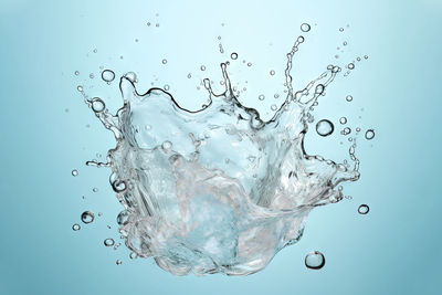 Close-up of water splashing against white background