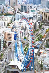 High angle view of ferris wheel in city