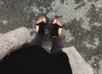 Close-up of woman standing on tiled floor