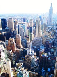 Aerial view of buildings in city against sky