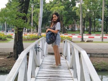 Portrait of smiling young woman on steps