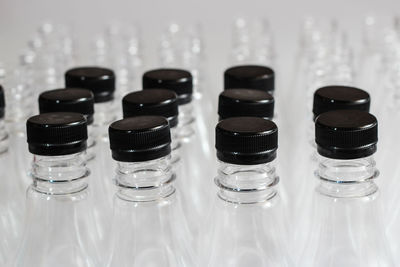 Close-up of empty glass bottles against gray background