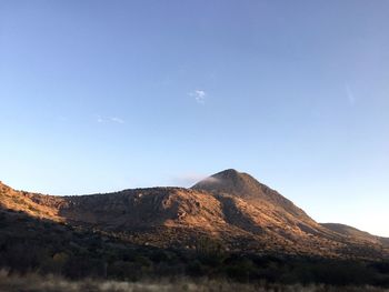 View of mountain range against blue sky