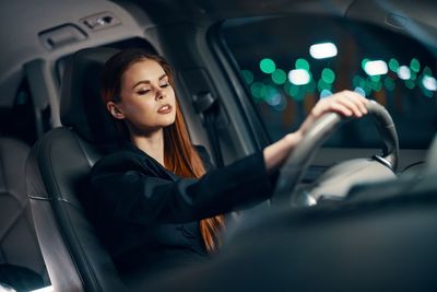 Frustrated young woman driving car