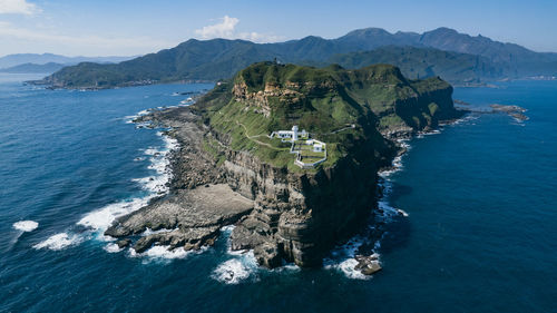 Scenic view of sea and mountains against sky