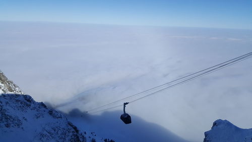 Low angle view of ski lift against sky