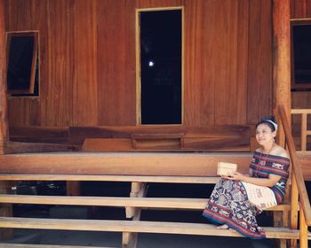 Portrait of woman sitting on bench