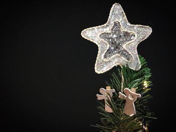 Close-up of illuminated christmas decoration against black background