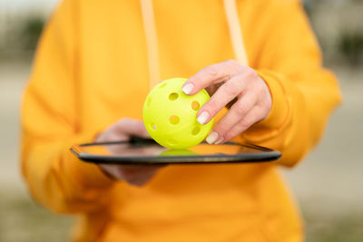 Midsection of man holding piggy bank