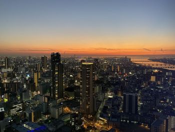 High angle view of illuminated buildings against sky during sunset