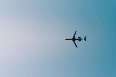 Low angle view of airplane flying in clear sky