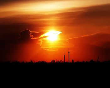 Scenic view of silhouette field against sky during sunset