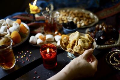 Cropped hand of woman holding food