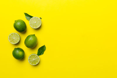 Directly above shot of fruits against yellow background