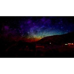 Scenic view of illuminated rainbow against sky at night