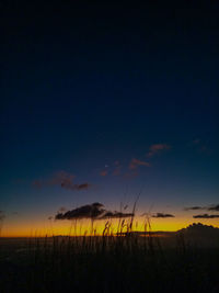 Scenic view of silhouette field against romantic sky at sunset