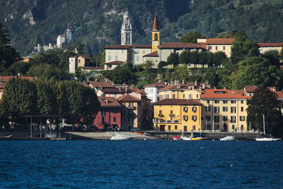 View of town by sea against buildings