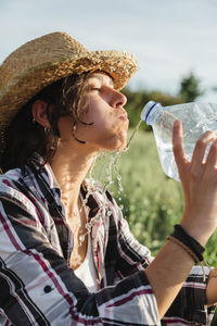 Portrait of man drinking water from bottle