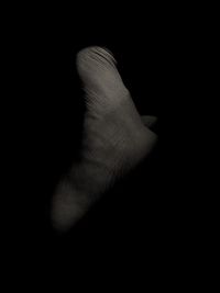 Close-up of human hand against black background