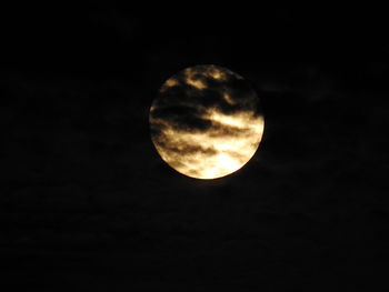 Low angle view of moon against dark sky