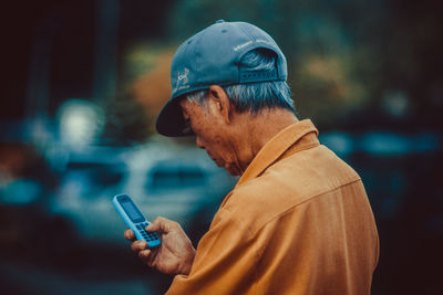 Midsection of man using mobile phone