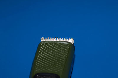 Low angle view of telephone pole against blue sky