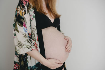 Pregnant woman with hands on her belly