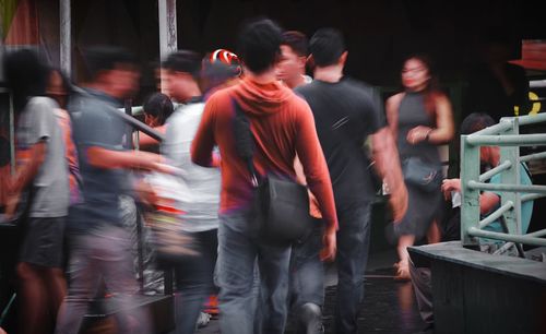 Blurred motion of people walking outdoors