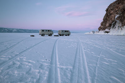 Two russian vans over icy lake