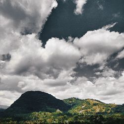 Scenic view of mountains against cloudy sky