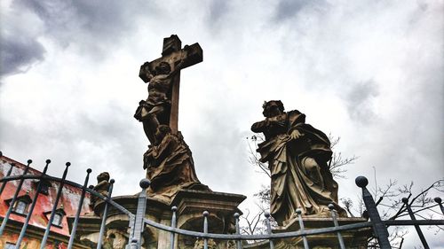 Low angle view of statue against cloudy sky