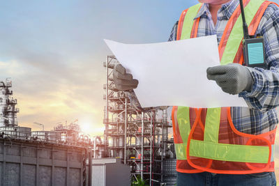 Man working at construction site against sky