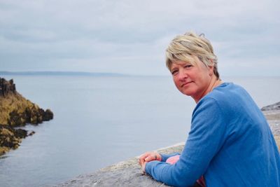 Portrait of mature woman against sea