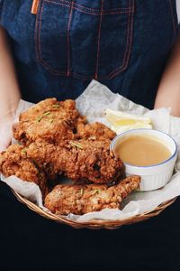 Midsection of person holding food in plate