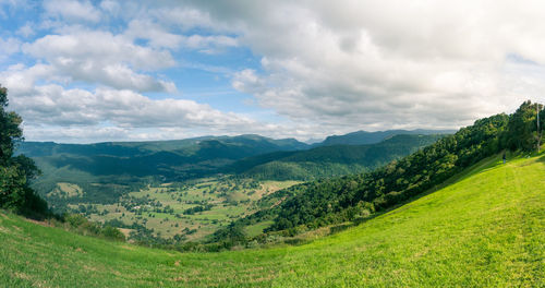 Scenic view of mountains against cloudy sky