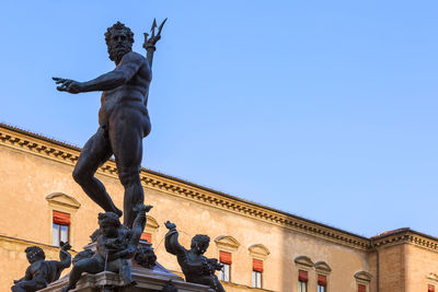 Low angle view of statue against blue sky