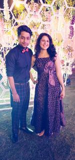 Portrait of young couple standing outdoors