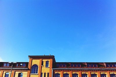 Low angle view of building against clear blue sky