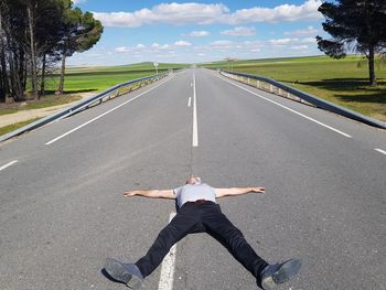 Full length of man lying on road