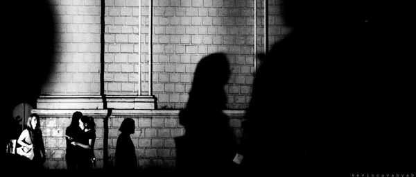 Shadow of silhouette woman on tiled floor