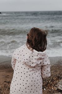 Rear view of woman looking at sea shore