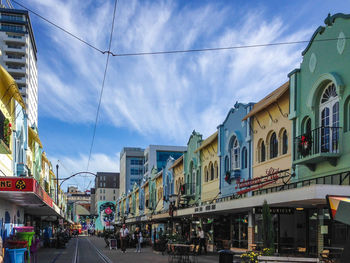 Panoramic view of city street and buildings against sky