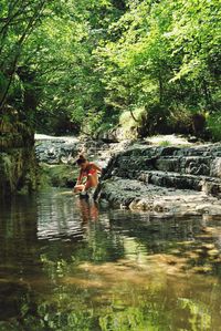 People standing on rocks in forest