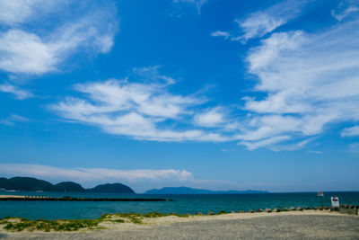 Scenic view of beach against blue sky