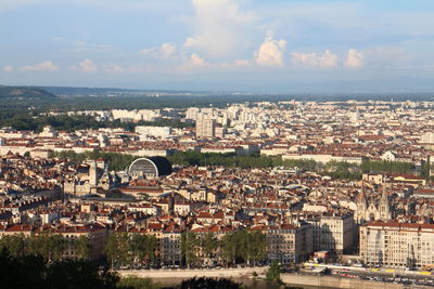 Cityscape against cloudy sky